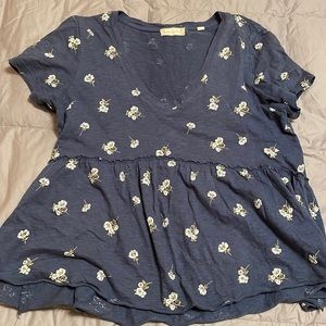 Flowy blue blouse with white flowers.